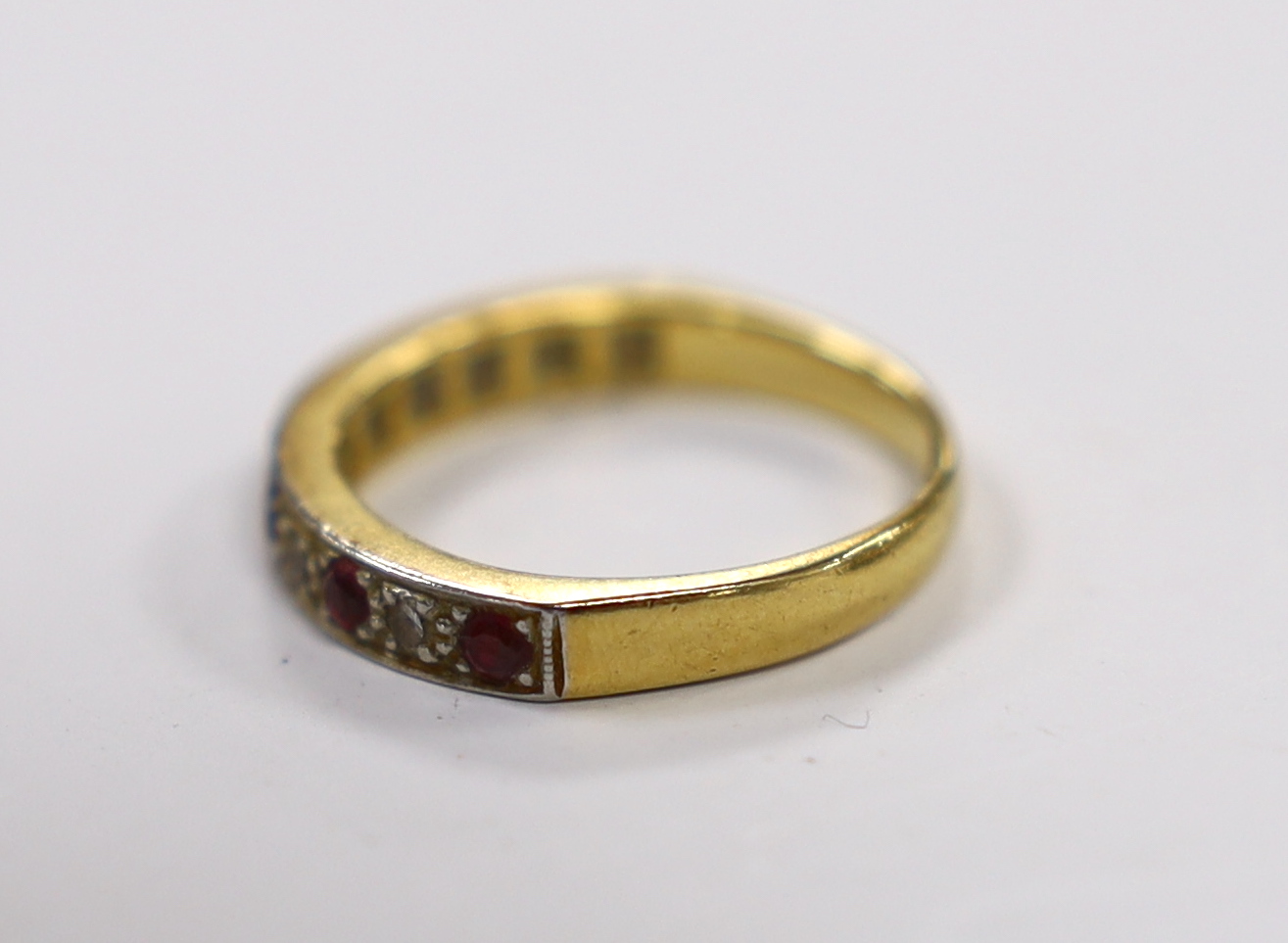 A 18ct and plat. six stone ruby and five stone diamond chip set half hoop ring, size L/M, gross weight 3.6 grams.